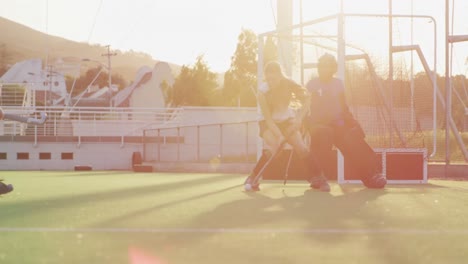 Female-hockey-players-playing-on-the-field