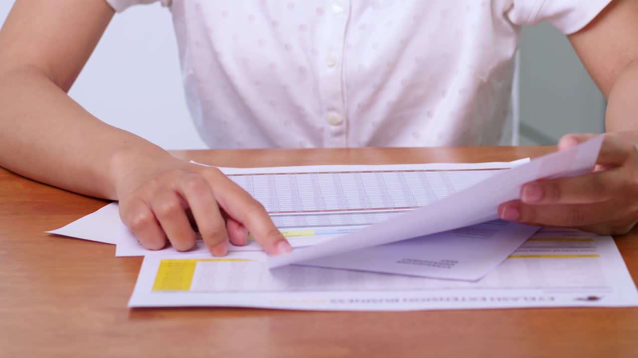 Organizing important documents on a desk home office paperwork professional close-up productivity
