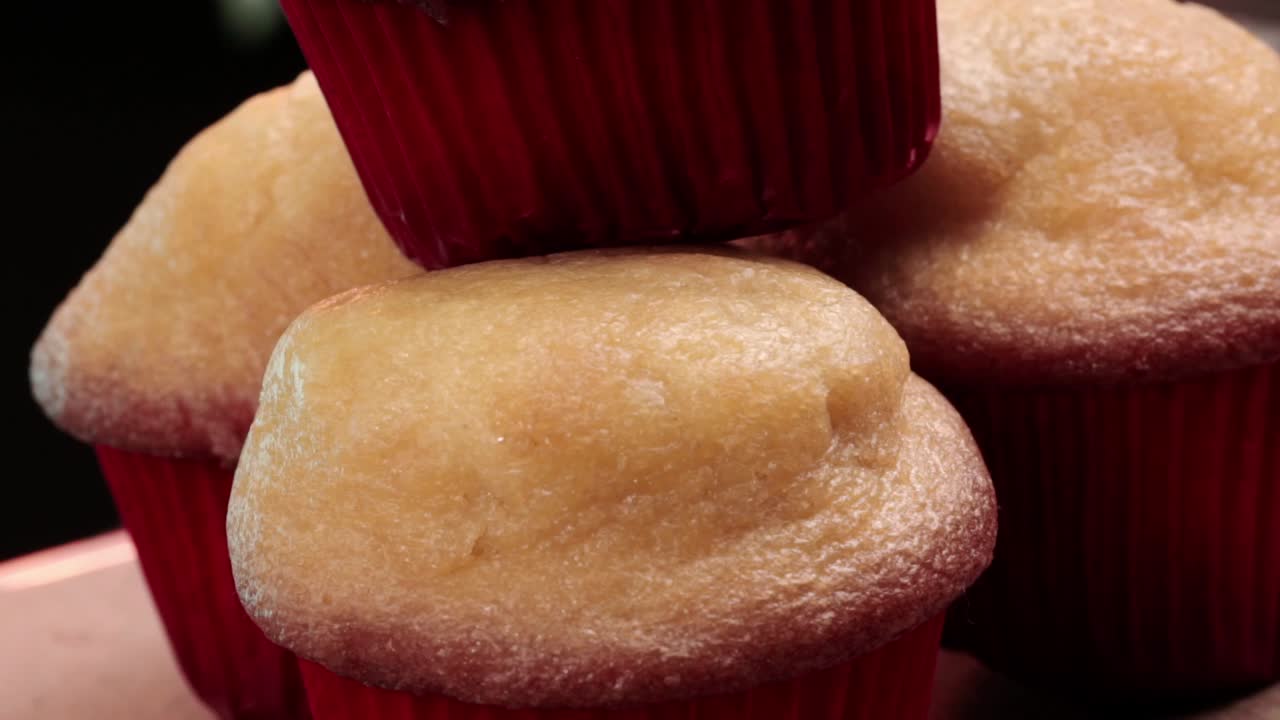 Static shot of four cupcakes on top of each other, close up