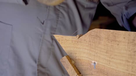 carpenter stripping wood from board