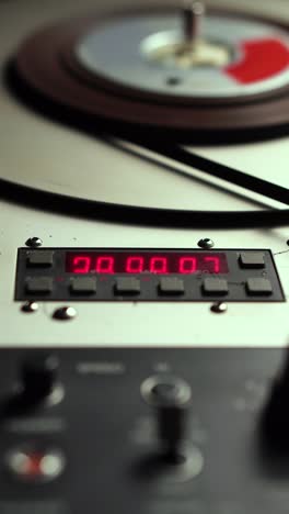 vertical 4k, time counter and spinning audio tape on professional reel to reel recorder player