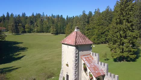 ancient castle tower of sneznik palace in slovenia, aerial ascending view