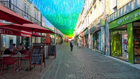 vibrant umbrellas adorn a bustling french street