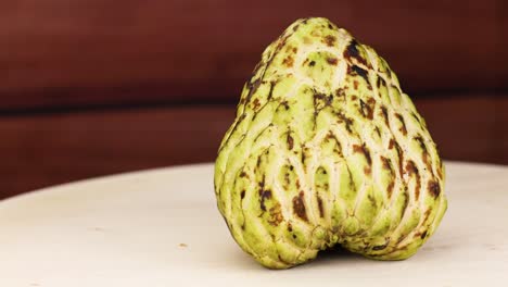 custard apple rotates on a wooden surface