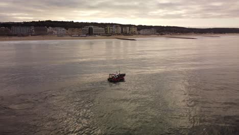 Tranquil-Scene-of-Boat-on-Beach-Coastline-of-Costa-da-Caparica,-Portugal---Static-Aerial-with-Copy-Space