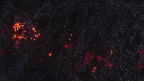 orange embers moving in steel wool fibers -slow motion