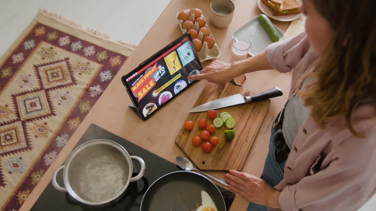 Woman Cooking Breakfast While Shopping Online