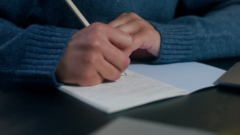 person writing in a notebook