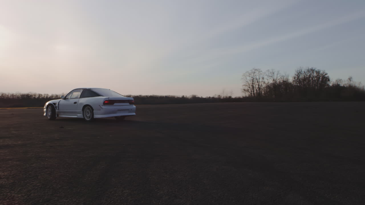 White Drift Car on a Track at Sunset