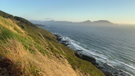 coastal cliffs at sunset overlooking to cies island in windy day
