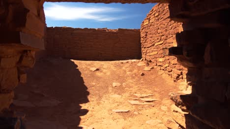 a drop-down into a stone doorway in the wukoki pueblo at wupatki national monument in arizona