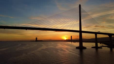 Cebu-Cordova-Link-Expressway,-Trucking-shot-against-a-dramatic-sunset