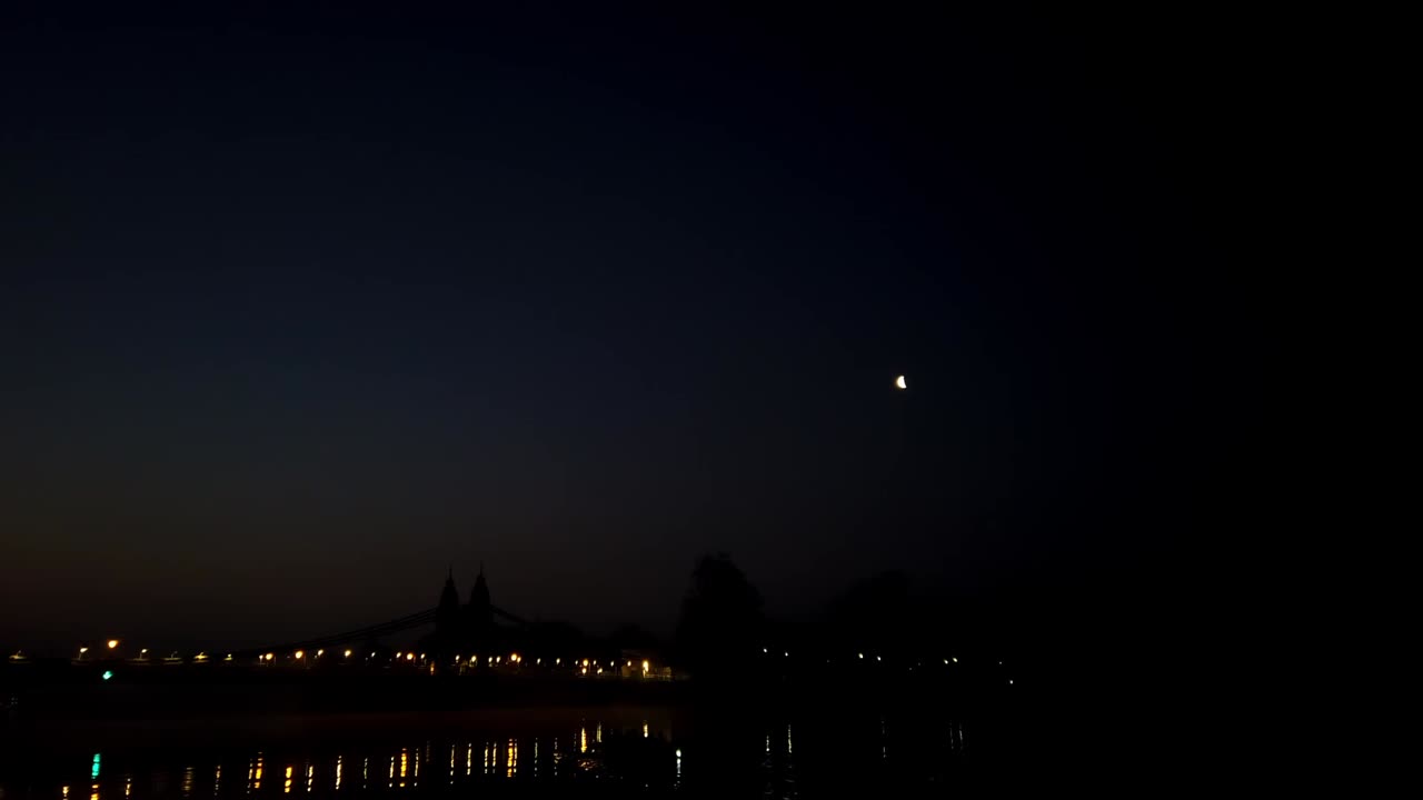 Motion lapse of foggy sunrise over Hammersmith Bridge, London