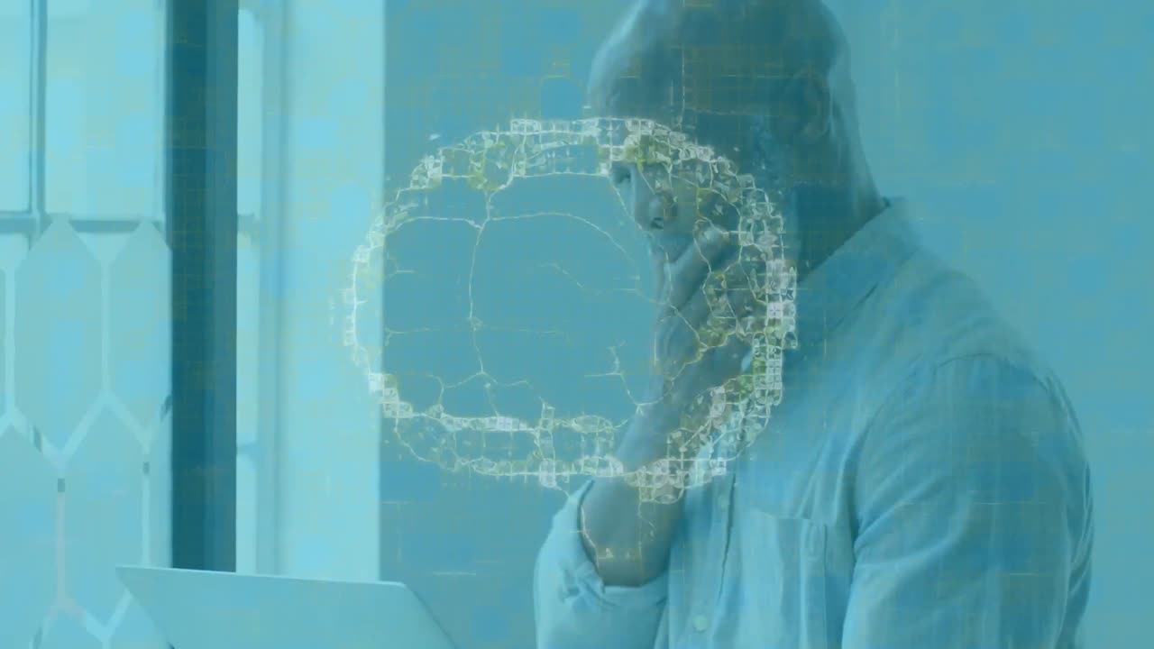 Animation of human brain spinning over businessman using laptop