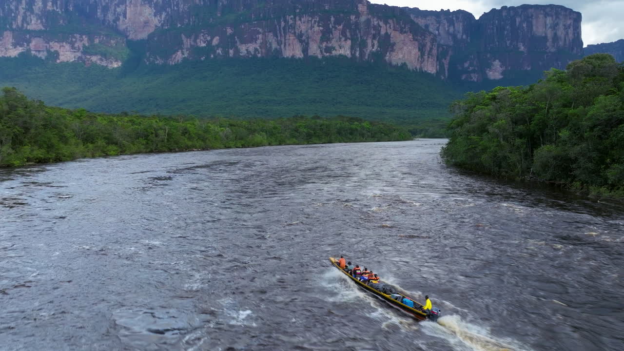Boat on a River with Tepui in the Background