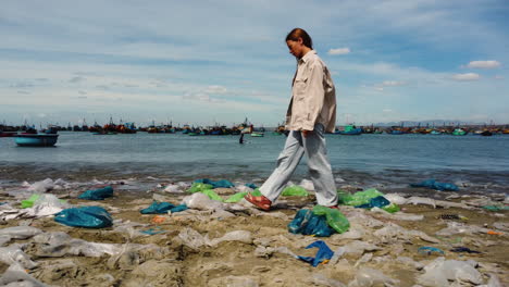 view of caucasian girl walking on plastic bags shore