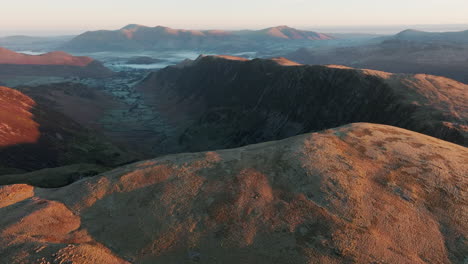 ancient mountains bathed in autumn dawn light with expansive view to other mountains and valleys