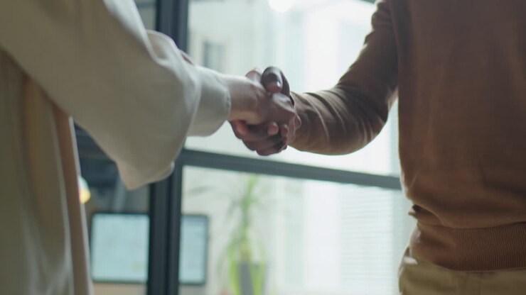 Handshake of Multiethnic Man and Woman in Office