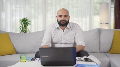 home office worker man looking dull at camera.