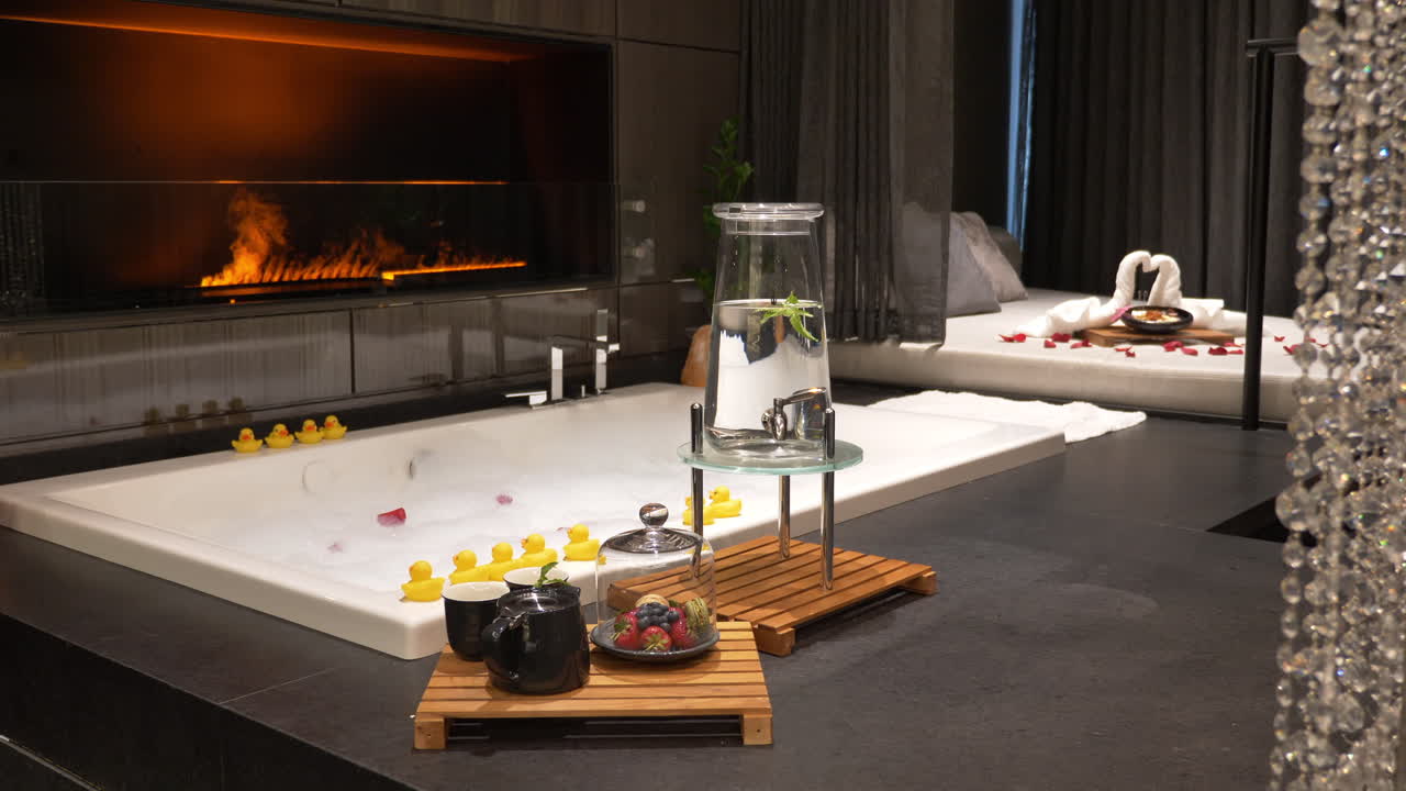 Honeymoon Luxury Hotel Suite with Big Bath in Front of Fake Fireplace