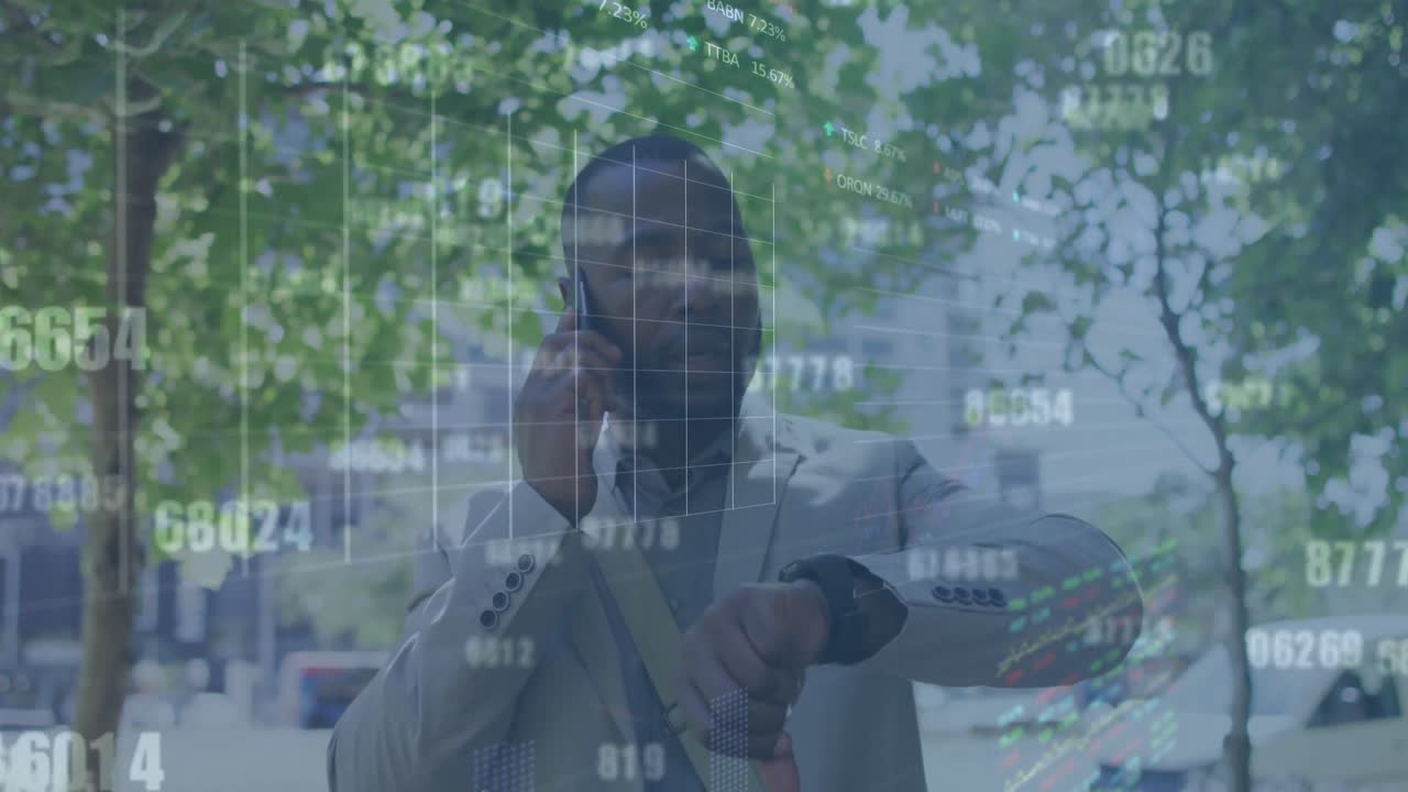 Animation of graphs, trading board, african american man talking on phone and looking at smartwatch