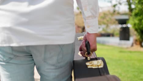 A-guitarist-is-carrying-a-guitar-case-and-walking-through-the-city