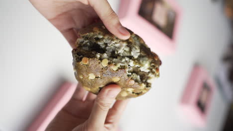Vertical-Shot---Female-Hands-Breaking-Home-Baked-Matcha-Cookie-Into-Two