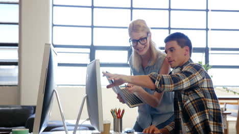 Casual-colleagues-pointing-at-computer