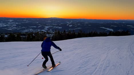telemark downhill skier skiing hafjell alpine ski resort øyer mountain norway norge vibrant artic sunset golden hour olympic torch man lillehammer clear skies groomed trail runs icy packed follow