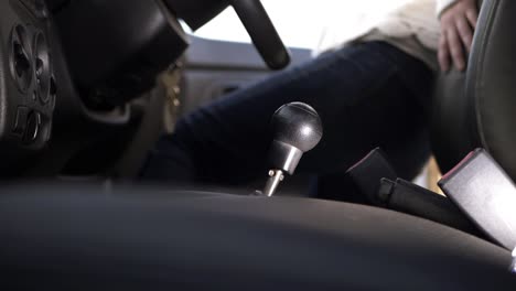 Female-driver-getting-into-car-interior--wide-shot