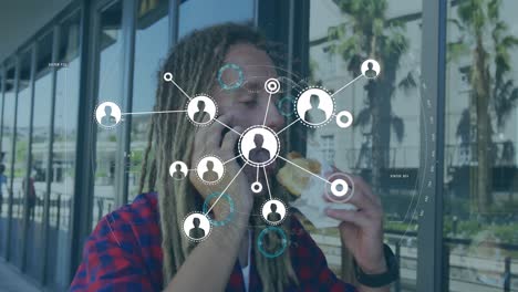 Animation-of-network-of-connections-with-icons-over-man-using-smartphone