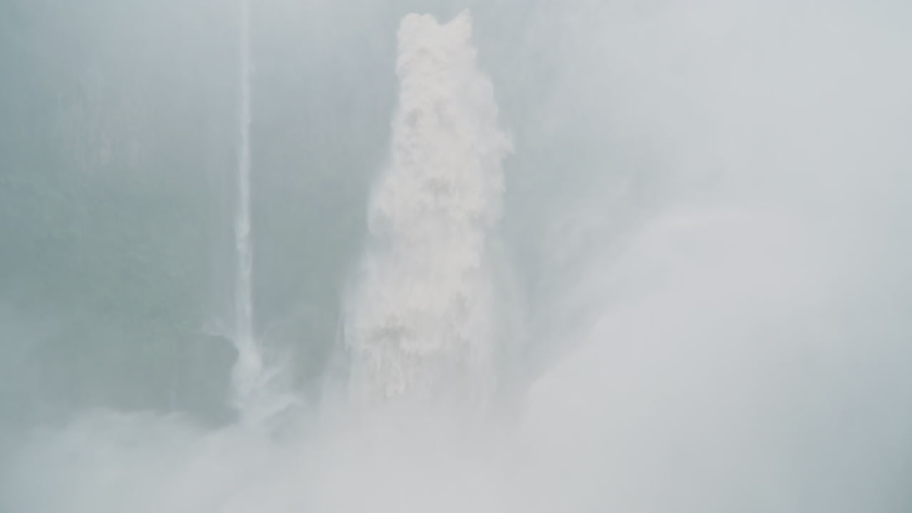 Man embraces power of massive jungle waterfall in height of rainy season
