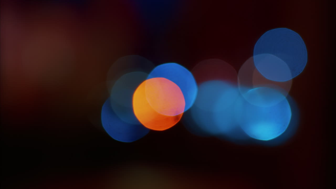 Abstract display of out-of-focus, colourful lights in a dark setting