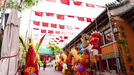 colorful dragon display with red flags overhead