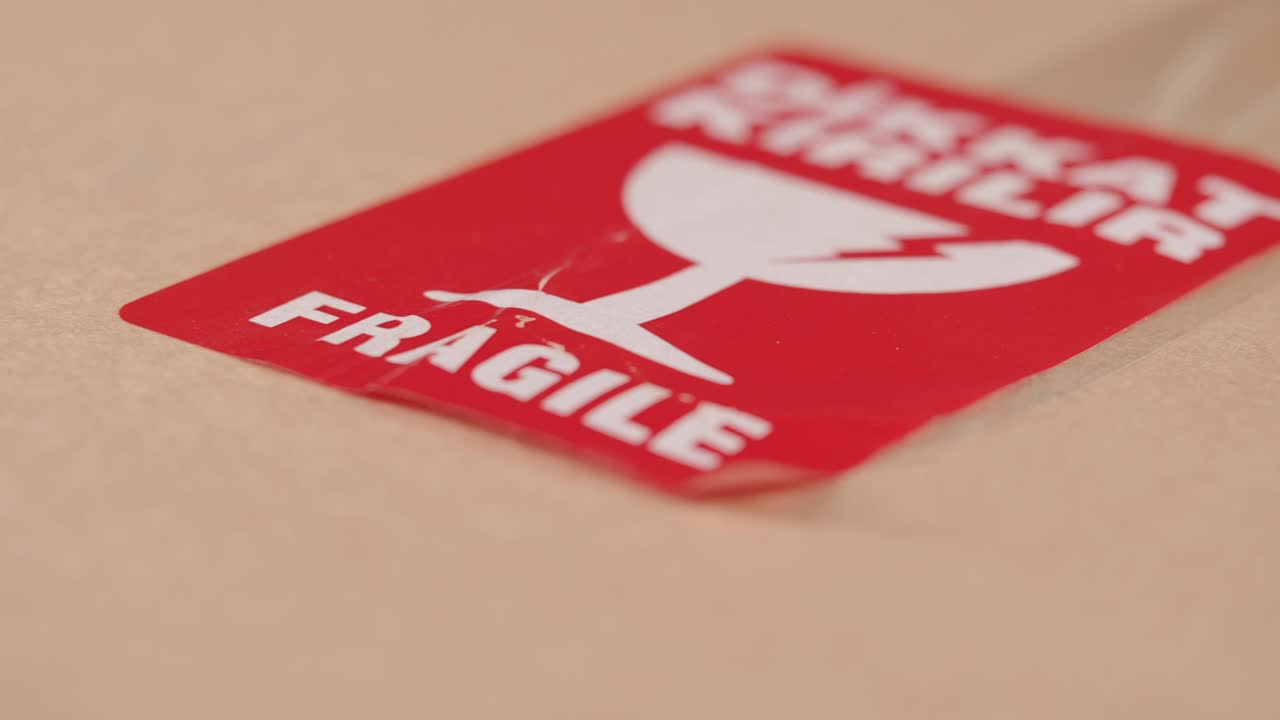 Close-up of Red Fragile Sticker on Cardboard Box