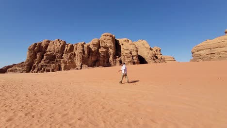 man crossing the desert of wadi rum