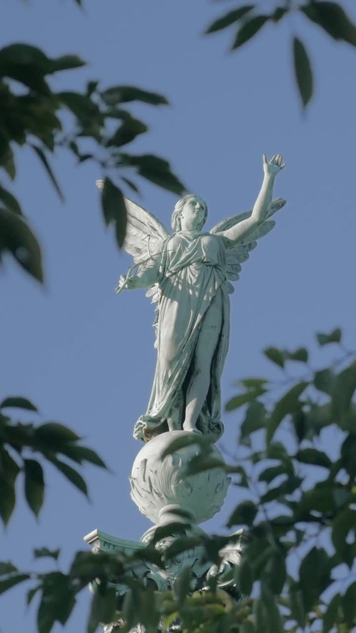 Winged Angel Statue Against Clear Blue Sky