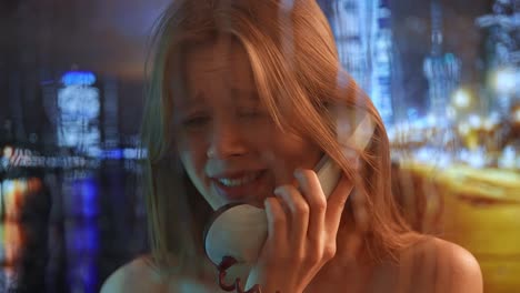 distressed woman talking on a vintage phone at night