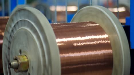 the process of drawing copper wires in the cable plant. coil with copper wire rotated on specialized equipment.