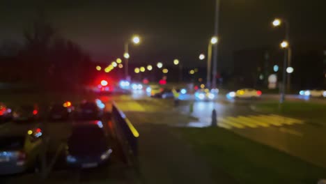 Car-crash-or-accident,-police-beacon-blurry-lights-at-night,-city-junction-soft-focus-view