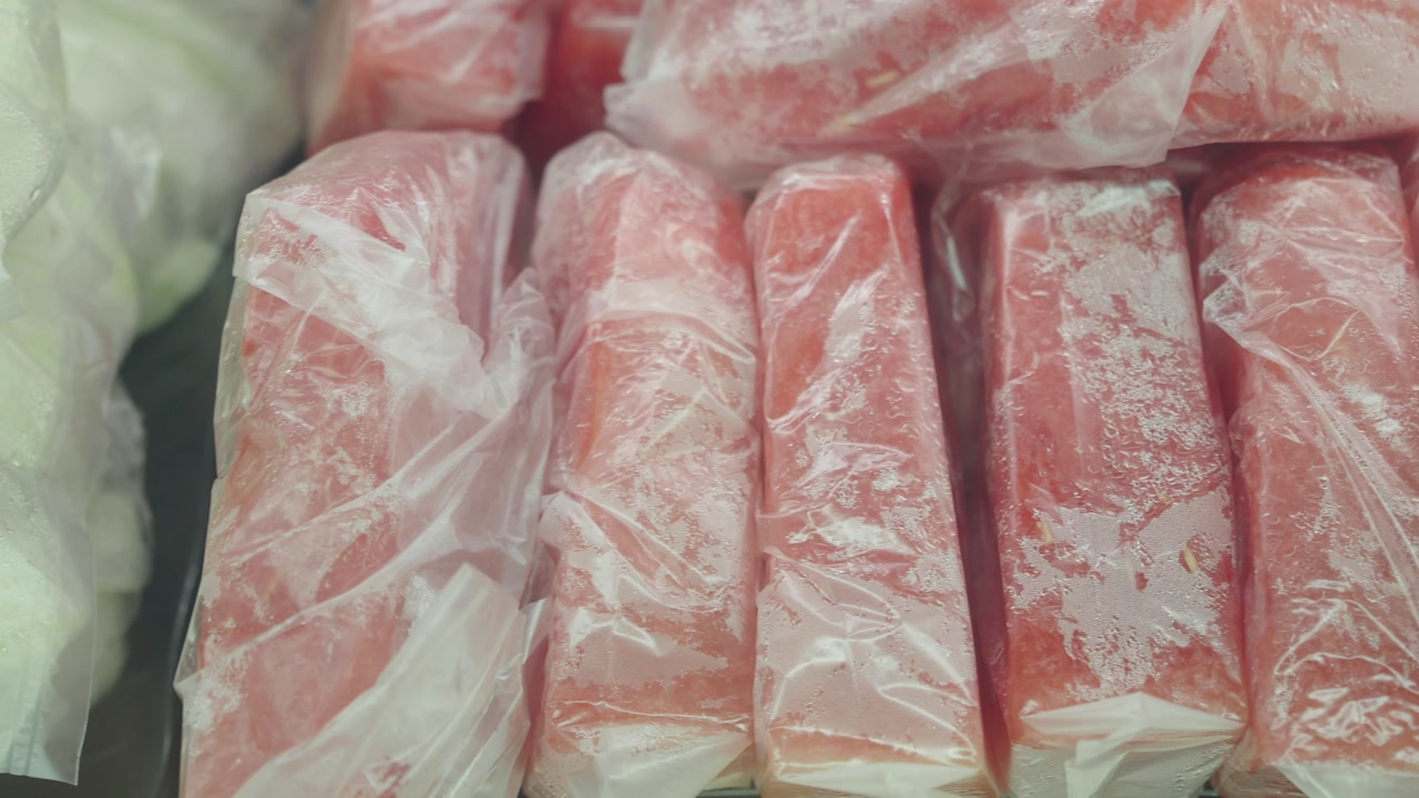 Frosty Red and Green Frozen Fruit Bars in Plastic Packaging
