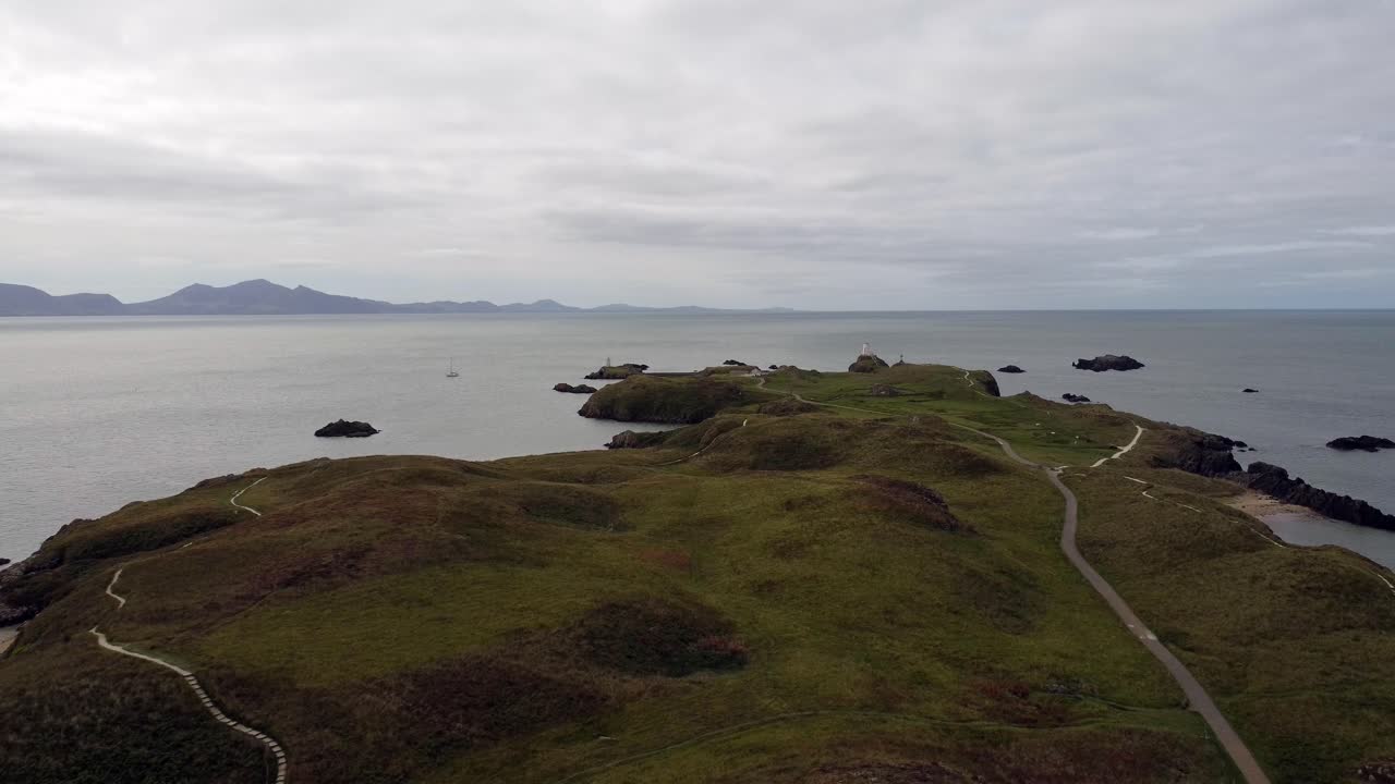 아일랜드 바다를 가로지르는 스노도니아 산맥이 있는 ynys llanddwyn 섬 앵글시 해안 산책로
