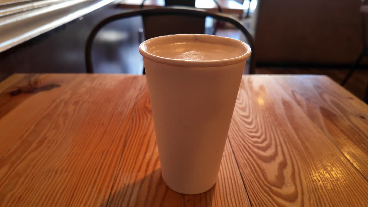 A warm vanilla latte rests on a café table in San Francisco, capturing a peaceful moment in a cozy urban setting.