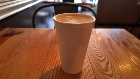 a warm vanilla latte rests on a café table in san francisco, capturing a peaceful moment in a cozy urban setting.
