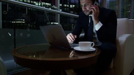 middle eastern businessman working with laptop smart phone