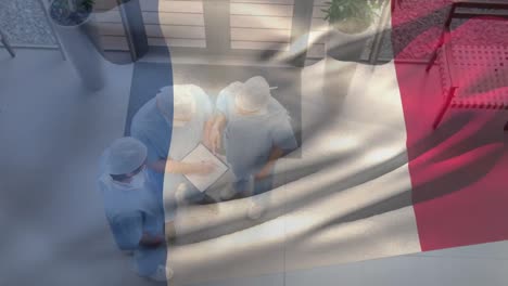 Animation-of-French-flag-with-healthcare-worker-in-background-during-coronavirus-pandemic