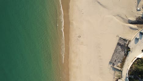 aerial top down view of idyllic shoreline of praia da luz, algarve