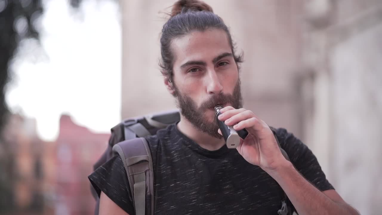 Man Smoking Outside a Church Tower