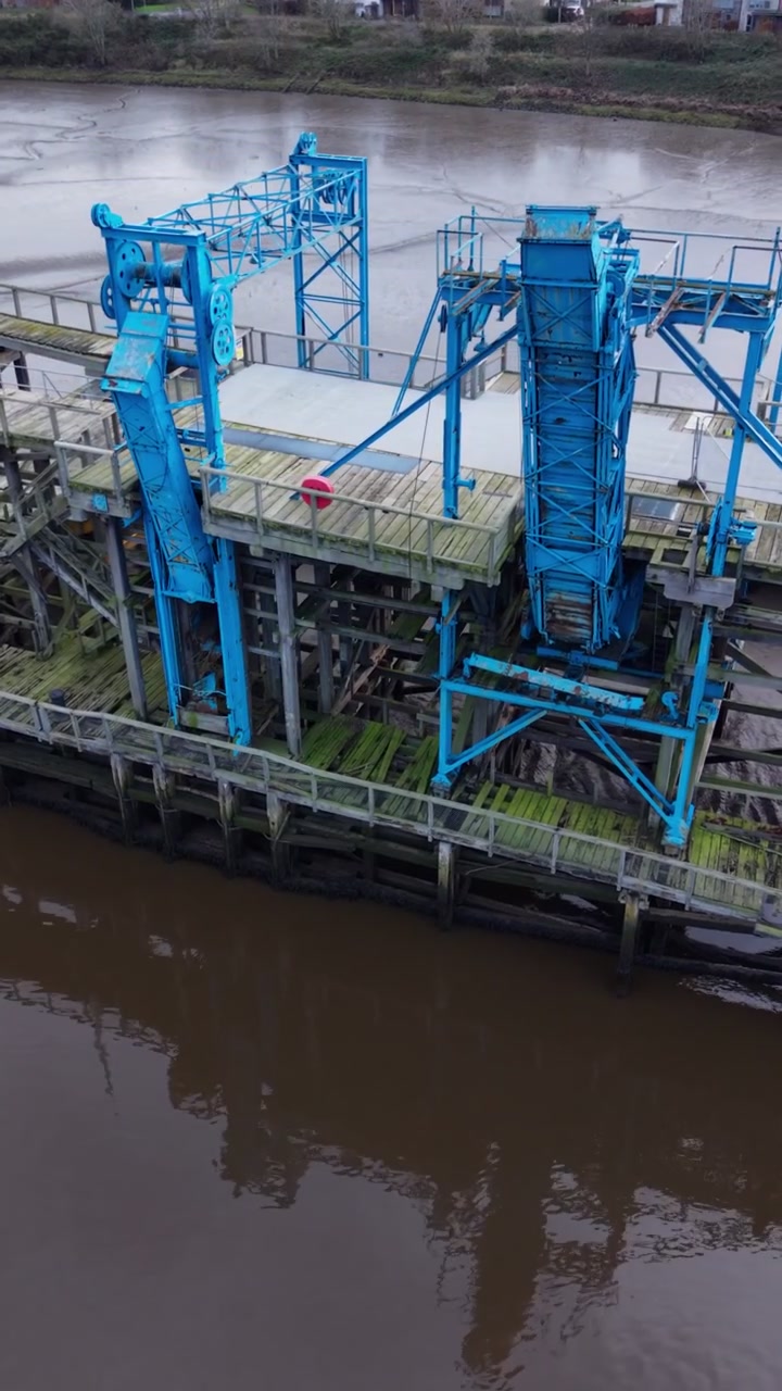 Close-up aerial pan of Dunston Staiths and loading chutes which would deliver coal from the upper deck onto the ships - Gateshead, England