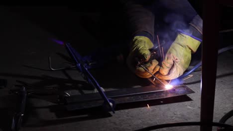 Right-angle-jig-being-welded-with-angular-precision,-closeup